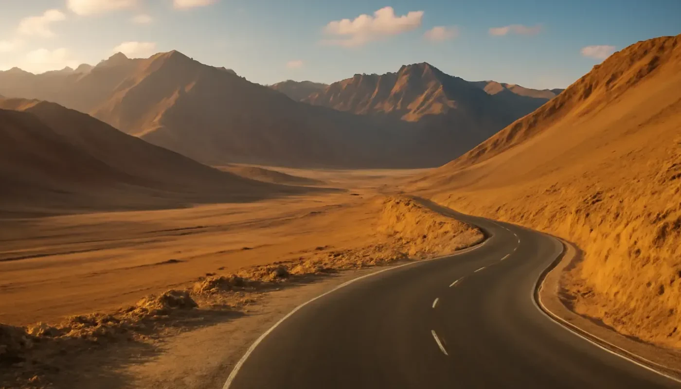 Winding road through a high-altitude Ladakh valley at golden hour