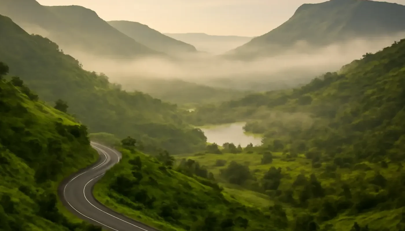 Misty green Sahyadri hills and a winding road near Lonavala in Maharashtra